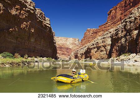 Stock Photography - Arizona, Grand Canyon National Park, Man Rafting On The Colorado River, Calm Water. Editorial Use Only.. Fotosearch