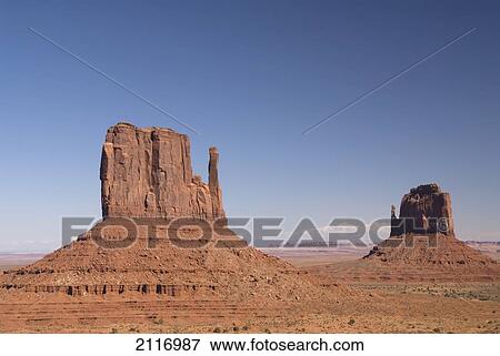 Arizona, Navajo Tribal Park, Monument Valley, View of the East and West Mitten Buttes in the desert. View Large Photo Image Stock Photo - Arizona, Navajo Tribal Park, Monument Valley, View of the East and West Mitten Buttes in the desert.. Fotosearch