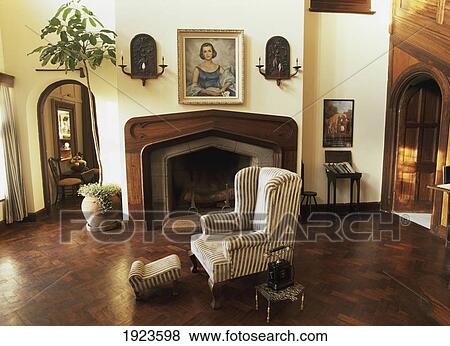 Stock Photo - Armchair Near Fireplace In Living Room. Fotosearch
