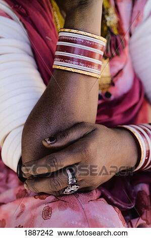 Stock Image - Arms Of Woman In Pink Sari Wearing Jewelry, Close Up. Fotosearch