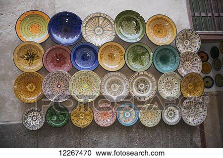 Array of beautifully designed plates for sale on wall display; Essaouira, Morocco View Large Photo Image Stock Image - Array of beautifully designed plates for sale on wall display; Essaouira, Morocco. Fotosearch