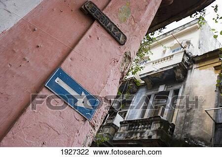 Stock Image - Arrow Sign On Old Buiding. Fotosearch