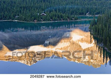 Stock Photo - Artist's Choice: Lake O'hara Lodge And Reflection Of Odaray Mountain In Lake O'hara At Sunrise, Yoho National Park, British Columbia. Fotosearch