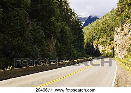 Stock Photo - Artist's Choice: Road Curving Through Mountain Landscape, Highway 37A, Northern British Columbia. Fotosearch