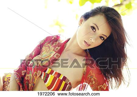 Stock Photograph - Asian Woman Models Colorful Fashion For The Beach.. Fotosearch