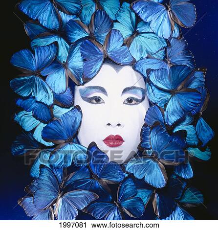 Stock Image - Asian Woman, White Face Surrounded By Blue Butterflies A01A. Fotosearch