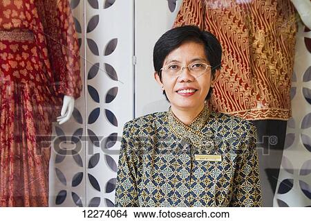 Picture - Asti Suryo, Assistant Manager of the Danar Hadi Batik Museum, Surakarta (Solo), Central Java, Indonesia. Fotosearch