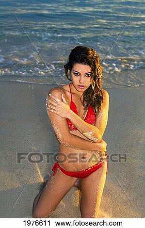 Stock Image - Attractive Girl In The Beautiful Sunset Light At The Beach.. Fotosearch