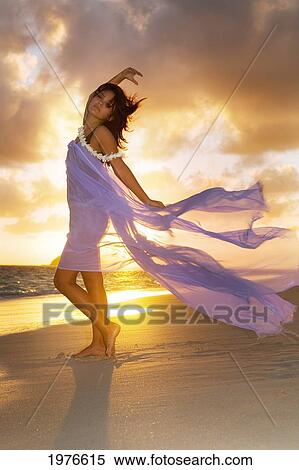 Stock Photography - Attractive Girl In The Beautiful Sunset Light At The Beach.. Fotosearch