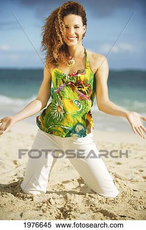 Stock Photography - Attractive Woman Playfin In The Sand At The Beach.. Fotosearch