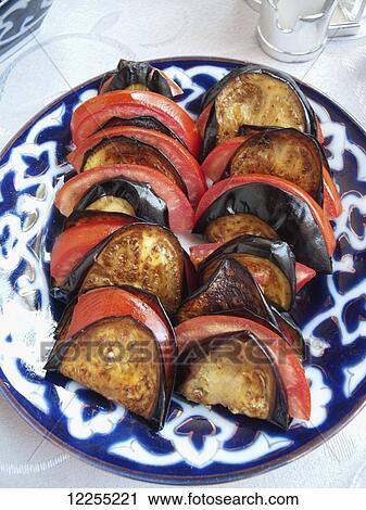 Stock Image - Aubergine and tomato salad, local restaurant, Ichan Kala Old City, Kizilkum desert; Khiva, Khwarezm region, Uzbekistan. Fotosearch
