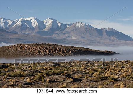 Aucanquilcha Volcano & Salar De Alconcha Salt Pan Covered By Fog, Antofagasta Region, Chile View Large Photo Image Picture - Aucanquilcha Volcano & Salar De Alconcha Salt Pan Covered By Fog, Antofagasta Region, Chile. Fotosearch
