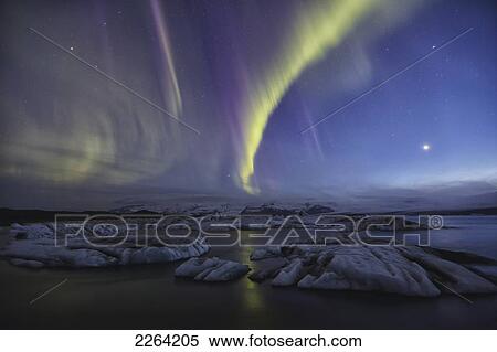 Stock Photography - Aurora borealis dances over the glacial lagoon jokulsarlon; iceland. Fotosearch