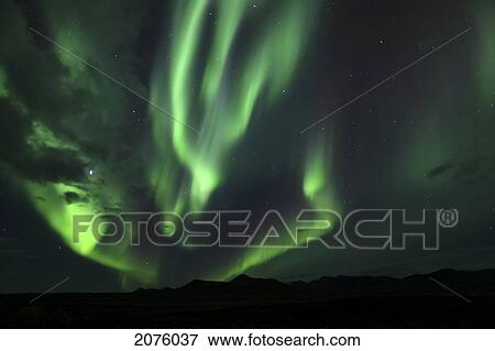 Stock Photo - Aurora Borealis Over Mountains Along The Dempster Highway; Yukon Canada. Fotosearch