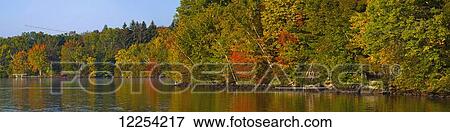 Autumn colours along the shoreline of a lake; Foster, Quebec, Canada View Large Photo Image Stock Photo - Autumn colours along the shoreline of a lake; Foster, Quebec, Canada. Fotosearch