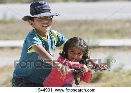 Aymara boy and girl on a bicycle, Volcan, Jujuy, Argentina View Large Photo Image Stock Image - Aymara boy and girl on a bicycle, Volcan, Jujuy, Argentina. Fotosearch