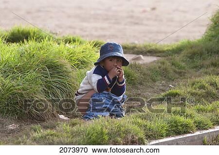 Stock Image - Aymara Girl Going Potty, Copacabana, La Paz Department, Bolivia. Fotosearch