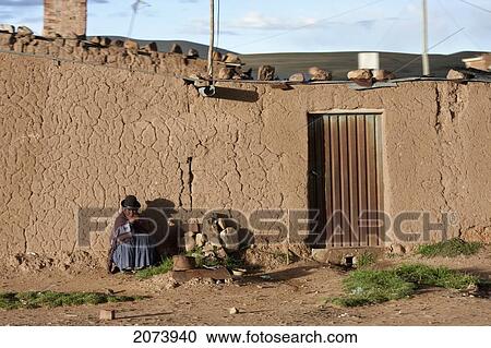 Aymara Woman Sitting In Front Of An Adobe House By The Road Between La Paz And Oruro, Bolivia View Large Photo Image Stock Image - Aymara Woman Sitting In Front Of An Adobe House By The Road Between La Paz And Oruro, Bolivia. Fotosearch