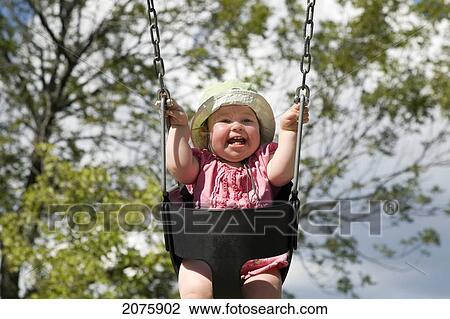 Baby Girl Laughing While She Swings; Ontario Canada View Large Photo Image Stock Image - Baby Girl Laughing While She Swings; Ontario Canada. Fotosearch