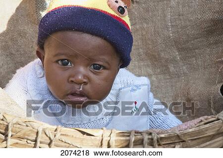 Stock Photo - Baby In A Basket At The Weekly Market In Fianarantsoa, Madagascar. Fotosearch