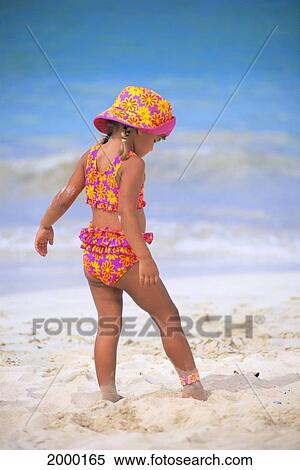 Stock Photography - Back Side View Of Little Girl Stepping Carefully In Sand, Matching Outfit. Fotosearch