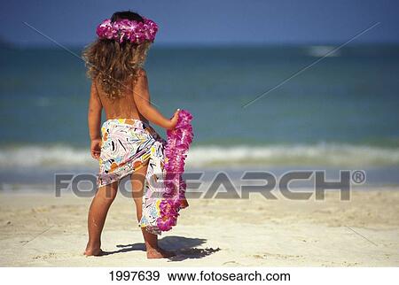 Stock Photo - Back View Of Little Girl At The Beach, Holding Pink Lei And Wearing A Pareo. Fotosearch