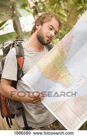 Stock Photo - Backpacker Looking At Map Of India. Fotosearch