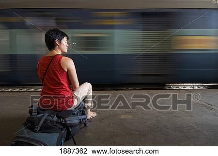 Backpacker Sitting On Rucksack In Train Station, Blurred Motion View Large Photo Image Stock Image - Backpacker Sitting On Rucksack In Train Station, Blurred Motion. Fotosearch