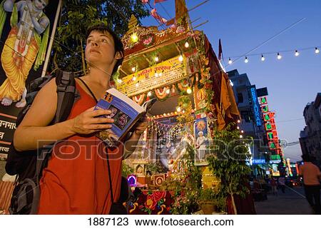Backpacker With Guidebook In Front Of Roadside Shrine At Dusk View Large Photo Image Stock Image - Backpacker With Guidebook In Front Of Roadside Shrine At Dusk. Fotosearch