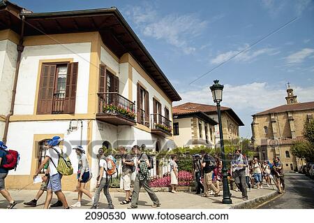 Stock Image - Backpackers Passing In Front Of Euskal Herria Museum, Gernika-Lumo, Basque Country, Spain. Fotosearch
