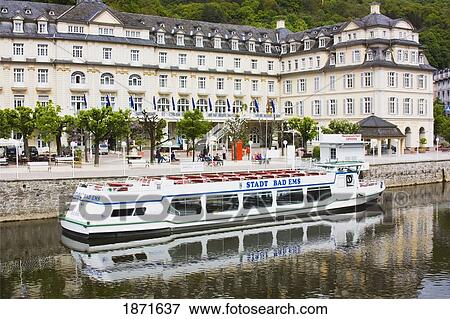 Bad Ems, Rheinland-Pfalz, Germany; A Boat And Building On The Waterfront Of The River Lahn View Large Photo Image Stock Photo - Bad Ems, Rheinland-Pfalz, Germany; A Boat And Building On The Waterfront Of The River Lahn. Fotosearch