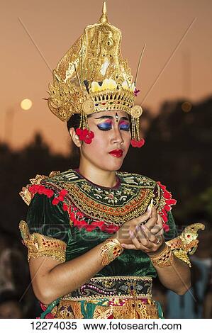 Stock Photography - Balinese dancer using codified hand positions and gestures during a Kecak dance performance, Ulu Watu, Bali, Indonesia. Fotosearch