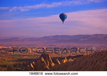 Stock Photograph - Balloons Over Goreme Valley, Cappadocia; Anatolia, Turkey. Fotosearch