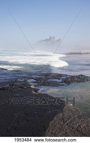 Picture - Bamburgh Castle In The Fog; Bamburgh Northumberland England. Fotosearch