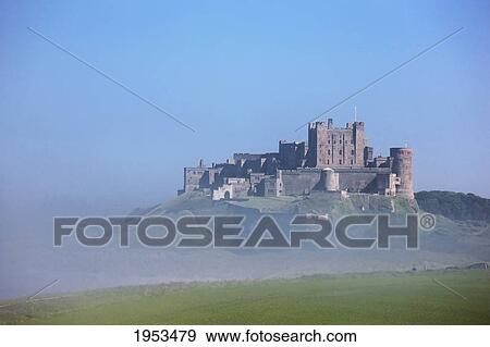 Stock Photo - Bamburgh Castle In The Fog; Bamburgh Northumberland England. Fotosearch