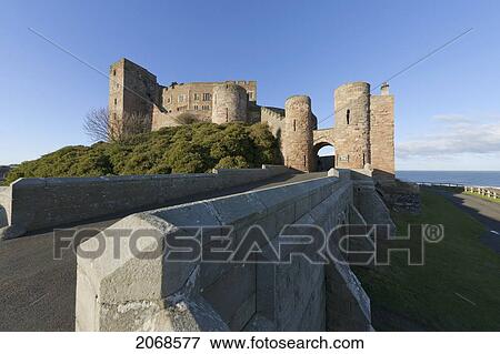 Bamburgh Castle Ruins Against A Blue Sky; Bamburgh Northumberland England View Large Photo Image Stock Photo - Bamburgh Castle Ruins Against A Blue Sky; Bamburgh Northumberland England. Fotosearch