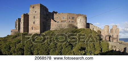 Bamburgh Castle Ruins Against A Blue Sky; Bamburgh Northumberland England View Large Photo Image Stock Photo - Bamburgh Castle Ruins Against A Blue Sky; Bamburgh Northumberland England. Fotosearch