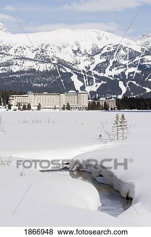 Stock Photo - Banff National Park, Alberta, Canada; Chateau Lake Louise And Ski Hills In Winter. Fotosearch