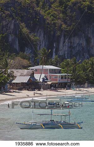 Bangka Boats Sit In The Picturesque And Scenic Bay; El Nido, Bacuit Archipelago, Palawan, Philippines View Large Photo Image Stock Photograph - Bangka Boats Sit In The Picturesque And Scenic Bay; El Nido, Bacuit Archipelago, Palawan, Philippines. Fotosearch