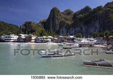 Bangka Boats Sit In The Picturesque And Scenic Bay; El Nido, Bacuit Archipelago, Palawan, Philippines View Large Photo Image Stock Photography - Bangka Boats Sit In The Picturesque And Scenic Bay; El Nido, Bacuit Archipelago, Palawan, Philippines. Fotosearch