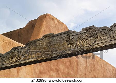Stock Photograph - Banner board over the entrance to a plaza off of Kit Carson street; Taos, New Mexico, United States of America. Fotosearch