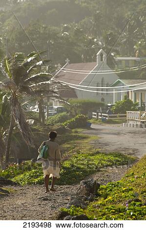 Stock Photo - Barbados, Woman walking to church early on Sunday morning; Bathsheba. Fotosearch