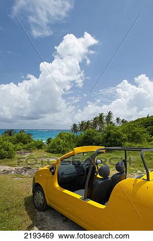 Stock Photo - Barbados, Yellow Moke parked in front of beach; Bottom Bay. Fotosearch