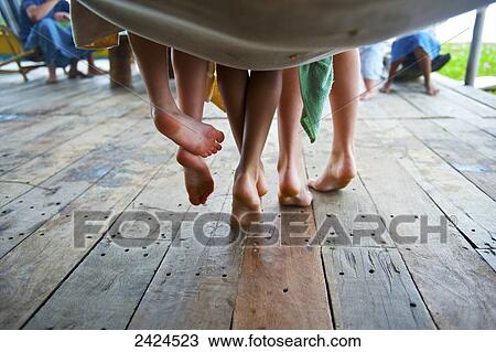 Stock Image - Bare feet hanging from a hammock; Ulpotha, Embogama, Sri Lanka. Fotosearch