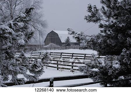 Stock Image - Barn roof and farmyard covered with snow in winter; Bromont, Quebec, Canada. Fotosearch