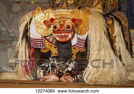 Picture - Barong, a mythical lion-like creature in a Barong dance performance by the Raja Peni troupe in the evening, Ubud, Bali, Indonesia. Fotosearch