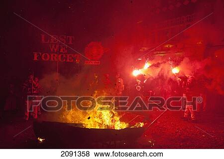 Stock Photo - Barrels Of Burning Torches In Front Of People With Red Flares And Banners At 'bonfire Prayers' At The End Of Bonfire Night, Lewes, East Sussex, Uk. Fotosearch