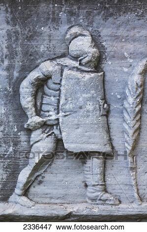 Stock Photo - Bas Relief Of A Roman Soldier With Helmet, Sword And Shield Outside The Ephesus Museum; Selcuk, Izmir Province, Turkey. Fotosearch