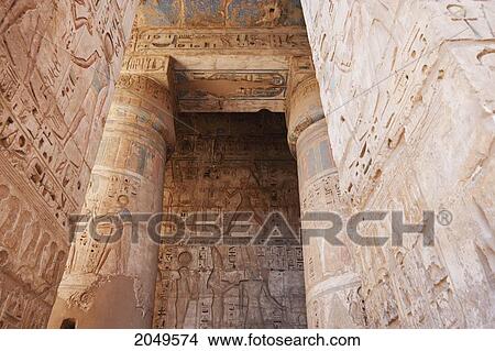 Picture - Bas-Reliefs With Original Colors On The Walls And Columns Of A Portico Of The Second Courtyard Of The Mortuary Temple Of Ramses Iii, Medinat Habu, Luxor, Qina, Egypt. Fotosearch