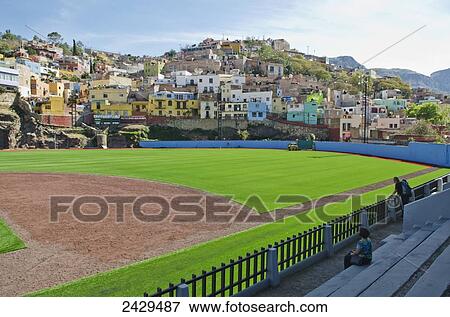 Stock Photo - Baseball park surrounded by old spanish mountainside homes; Guanajuato, Mexico. Fotosearch